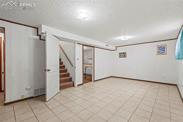 930 Bowser Dr, Colorado Springs, CO 80909 - finished below grade area featuring stairs, a textured ceiling, and baseboards