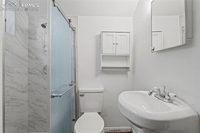 930 Bowser Dr, Colorado Springs, CO 80909 - bathroom featuring a stall shower, toilet, and a sink