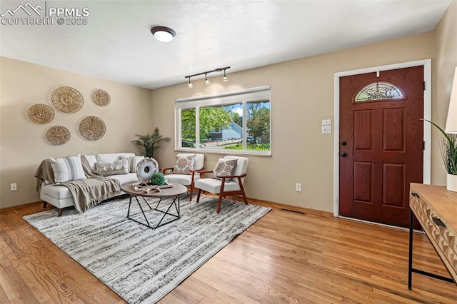 930 Bowser Dr, Colorado Springs, CO 80909 - living area with plenty of natural light, light wood-type flooring, and baseboards