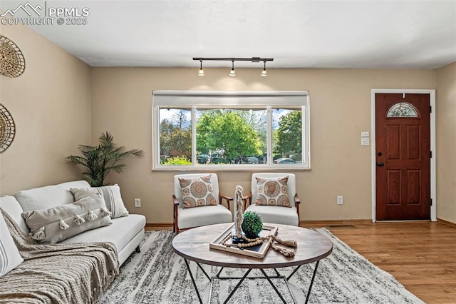930 Bowser Dr, Colorado Springs, CO 80909 - living area with baseboards, wood finished floors, and rail lighting