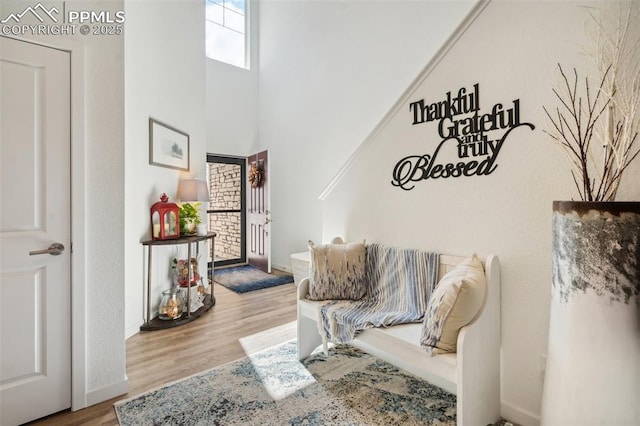 living area featuring baseboards and wood finished floors