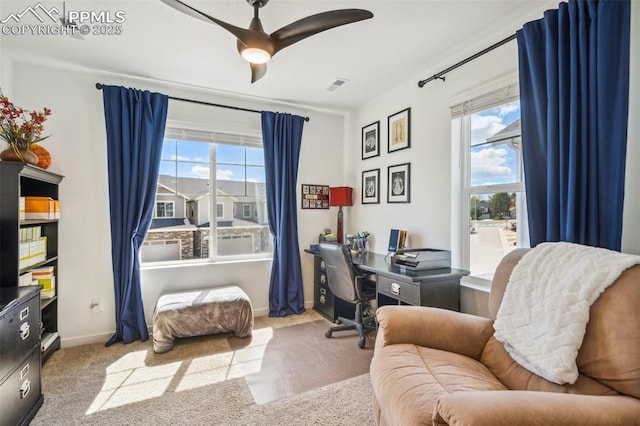 office featuring plenty of natural light, baseboards, carpet floors, and visible vents