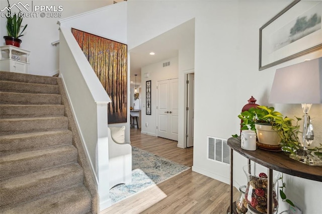 entrance foyer featuring visible vents, recessed lighting, wood finished floors, and stairway