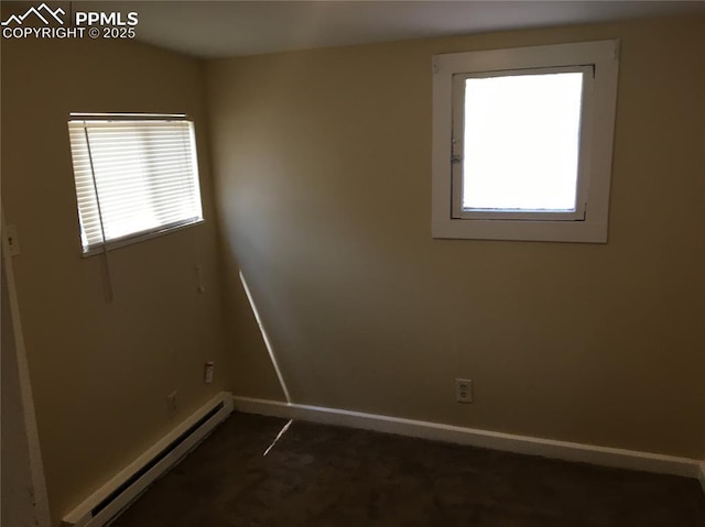 unfurnished room featuring a baseboard radiator, dark colored carpet, a healthy amount of sunlight, and baseboards
