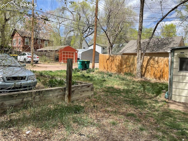 522 N Spruce St, Colorado Springs, CO 80905 - view of yard featuring fence, a storage shed, and an outdoor structure