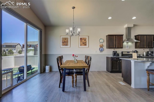 dining room featuring a chandelier, light wood finished floors, and recessed lighting