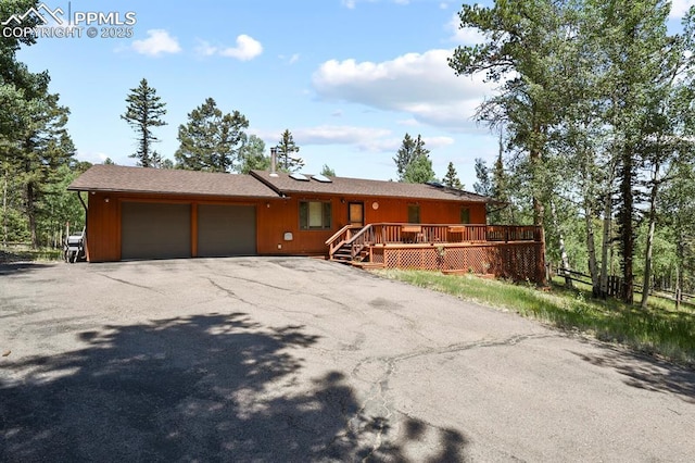 view of front of house featuring a garage and aphalt driveway
