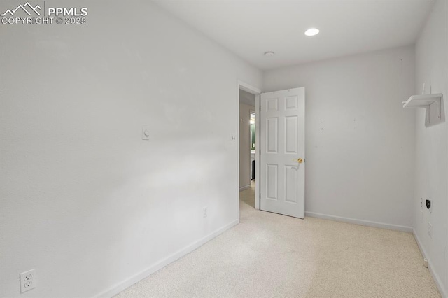 carpeted empty room featuring baseboards and recessed lighting