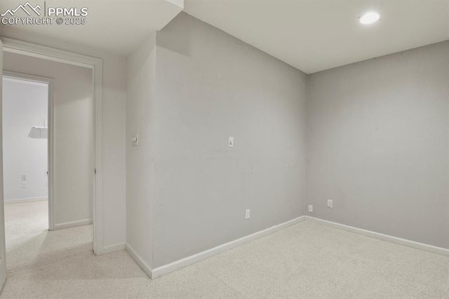 carpeted spare room featuring baseboards and recessed lighting