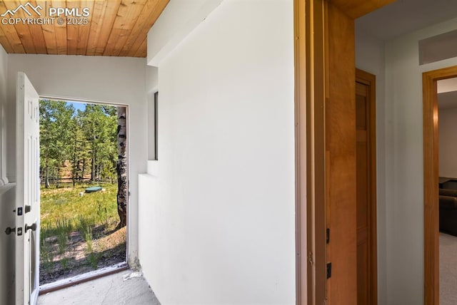 doorway to outside featuring wooden ceiling
