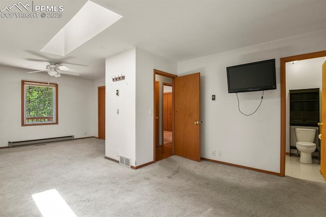 unfurnished living room with baseboard heating, baseboards, a ceiling fan, carpet floors, and visible vents