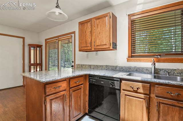 kitchen featuring brown cabinetry, a peninsula, dishwasher, and a sink