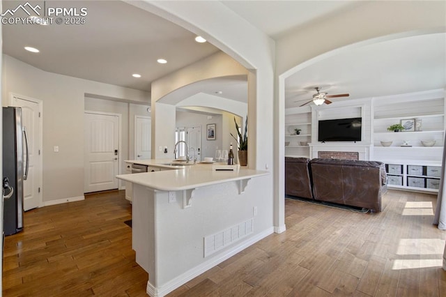 12529 Culebra Peak Dr, Peyton, CO 80831 - kitchen with wood finished floors, visible vents, a sink, freestanding refrigerator, and ceiling fan