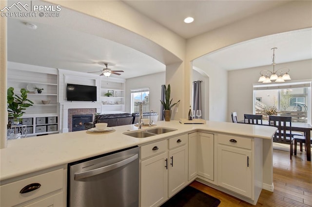 12529 Culebra Peak Dr, Peyton, CO 80831 - kitchen featuring ceiling fan with notable chandelier, dishwasher, light countertops, and hanging light fixtures