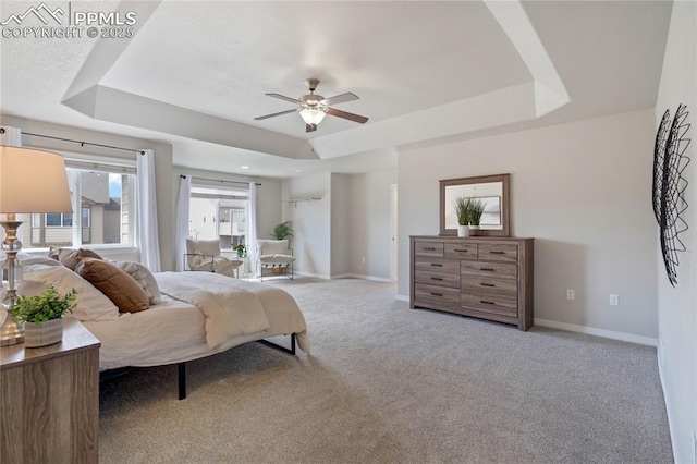 12529 Culebra Peak Dr, Peyton, CO 80831 - carpeted bedroom featuring ceiling fan, baseboards, and a tray ceiling
