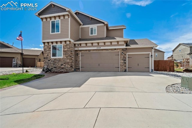 12529 Culebra Peak Dr, Peyton, CO 80831 - craftsman inspired home featuring a garage, stone siding, concrete driveway, and fence