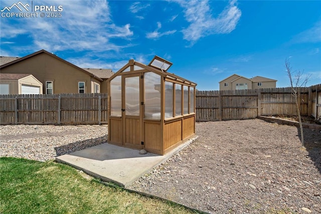 12529 Culebra Peak Dr, Peyton, CO 80831 - view of yard featuring a fenced backyard, an outbuilding, and a greenhouse