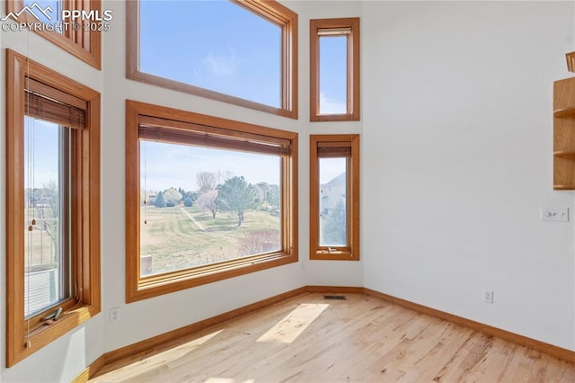 18 Redondo Ln, Pueblo, CO 81005 - spare room with visible vents, baseboards, a high ceiling, and wood finished floors