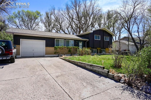 219 Fairfax St, Colorado Springs, CO 80911 - split level home featuring an attached garage, a front lawn, driveway, and board and batten siding