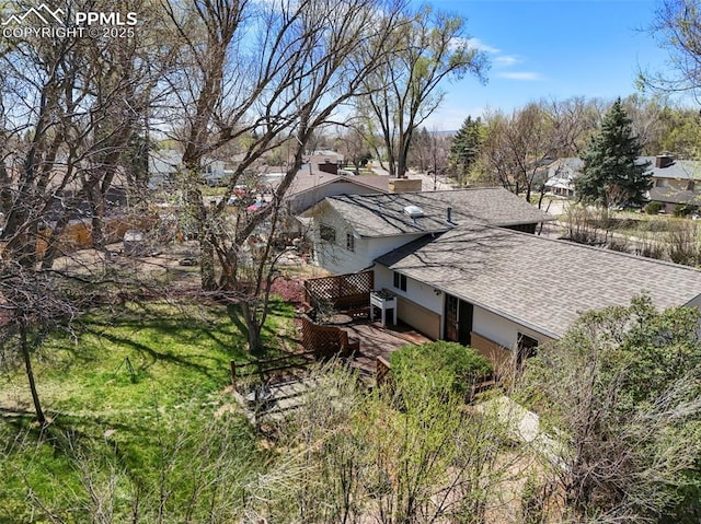 219 Fairfax St, Colorado Springs, CO 80911 - view of side of home featuring a chimney, roof with shingles, and a residential view