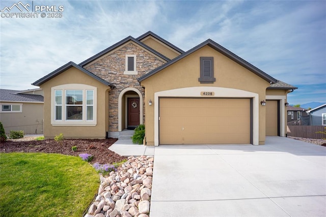 4225 New Santa Fe Trl, Colorado Springs, CO 80924 - view of front of home with stone siding, stucco siding, a garage, and driveway