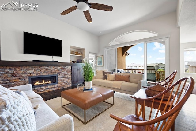 4225 New Santa Fe Trl, Colorado Springs, CO 80924 - living room featuring ceiling fan, wood finished floors, a stone fireplace, and built in features