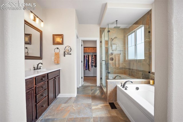 4225 New Santa Fe Trl, Colorado Springs, CO 80924 - full bath featuring stone tile floors, a stall shower, baseboards, vanity, and a garden tub