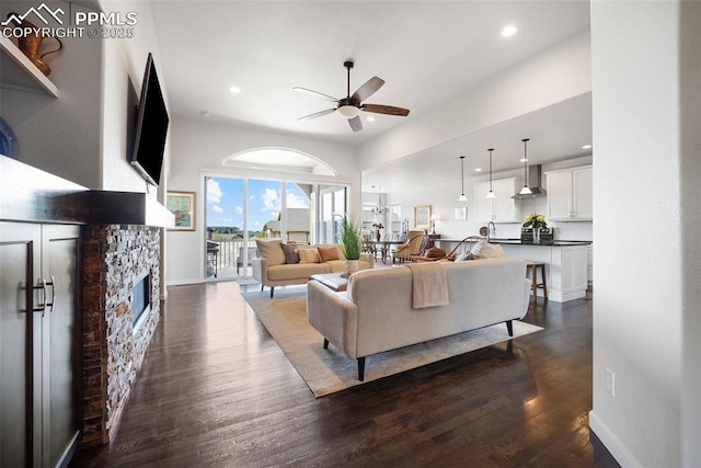 4225 New Santa Fe Trl, Colorado Springs, CO 80924 - living area with a ceiling fan, dark wood-style flooring, a stone fireplace, recessed lighting, and baseboards