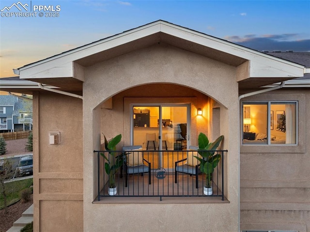 1530 Little Bear Creek Pt Unit 302, Colorado Springs, CO 80904 - exterior entry at dusk with stucco siding