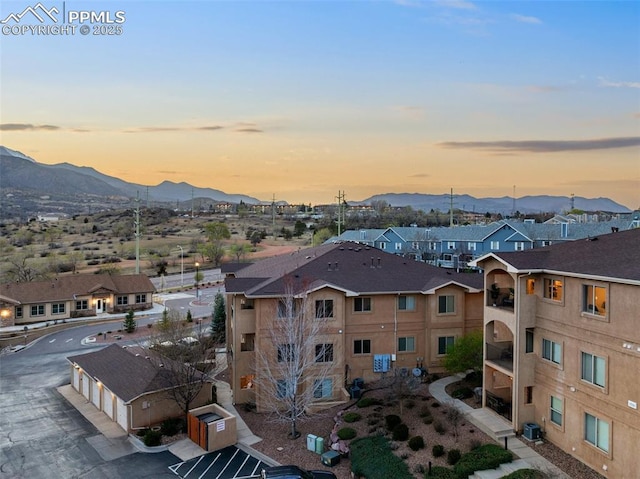 1530 Little Bear Creek Pt Unit 302, Colorado Springs, CO 80904 - aerial view at dusk with a residential view and a mountain view