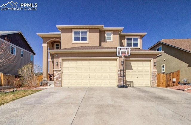 10585 Abrams Dr, Colorado Springs, CO 80925 - view of front of property with a garage, stucco siding, fence, stone siding, and concrete driveway