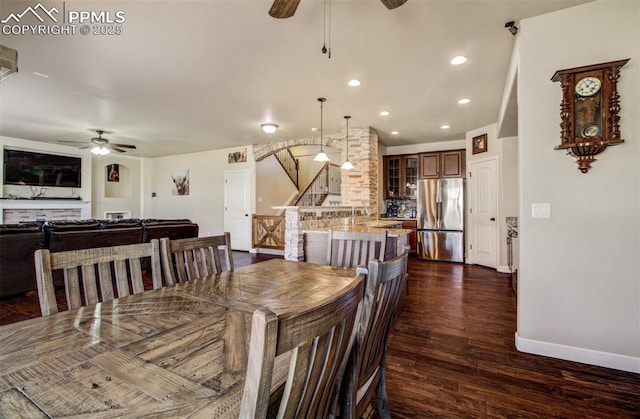 10585 Abrams Dr, Colorado Springs, CO 80925 - dining space with a ceiling fan, stairway, recessed lighting, dark wood-style flooring, and baseboards