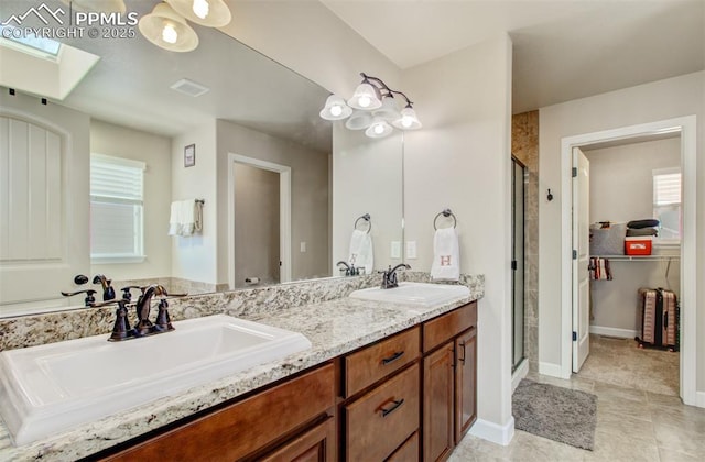 10585 Abrams Dr, Colorado Springs, CO 80925 - bathroom with a sink, visible vents, a skylight, and a stall shower