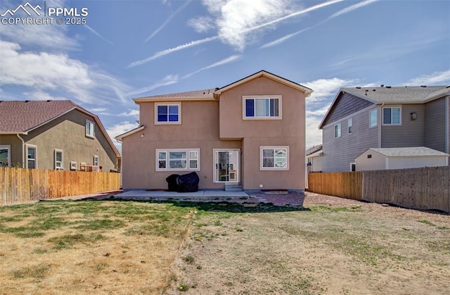 10585 Abrams Dr, Colorado Springs, CO 80925 - rear view of property with a patio, stucco siding, a fenced backyard, and a lawn