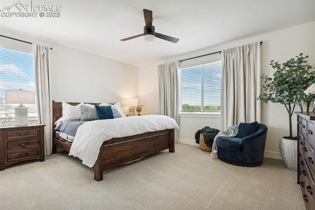 bedroom with light colored carpet, ceiling fan, and baseboards