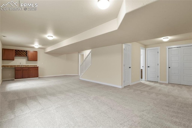 147 Celestine St, Colorado Springs, CO 80905 - finished basement featuring stairway, baseboards, wet bar, and light carpet
