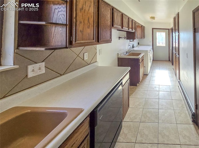 722 6th St, Hugo, CO 80821 - kitchen featuring dishwasher, a sink, light countertops, light tile patterned flooring, and backsplash