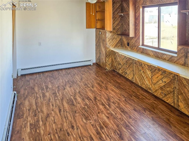 722 6th St, Hugo, CO 80821 - kitchen with baseboard heating, brown cabinets, a baseboard heating unit, and wood finished floors