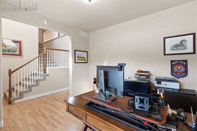 home office with baseboards, visible vents, and wood finished floors