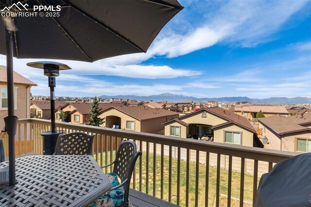 wooden terrace with a mountain view and a residential view