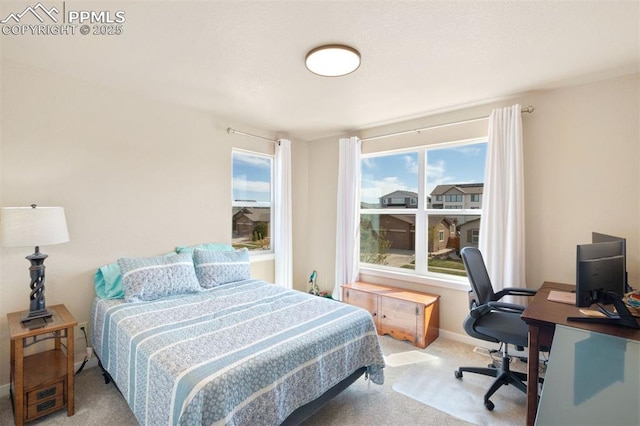 carpeted bedroom featuring baseboards