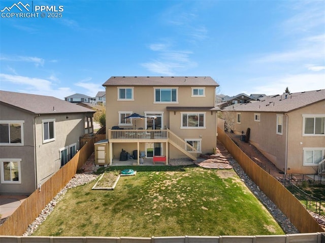 back of property featuring a wooden deck, a patio, a fenced backyard, stucco siding, and stairway