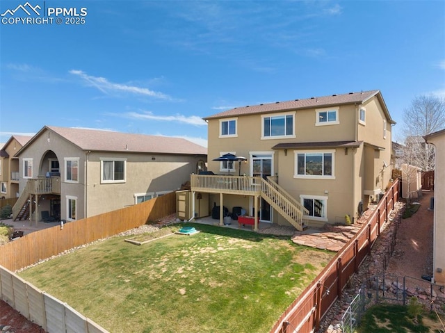 rear view of property featuring stairs, a fenced backyard, a patio area, and a deck