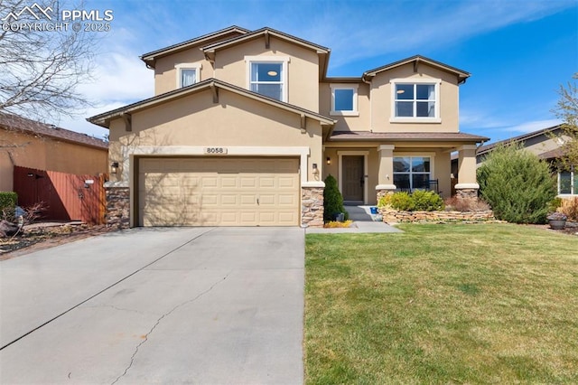 view of front of home with stone siding, a garage, stucco siding, a front yard, and concrete driveway