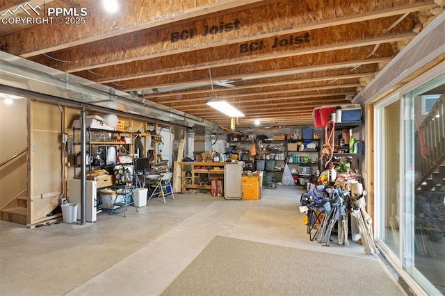 basement featuring a workshop area and stairway