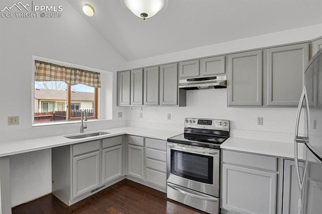 kitchen featuring vaulted ceiling, a sink, electric range, under cabinet range hood, and gray cabinetry