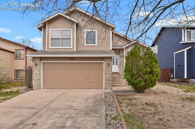 view of front of house featuring fence, driveway, brick siding, and a garage