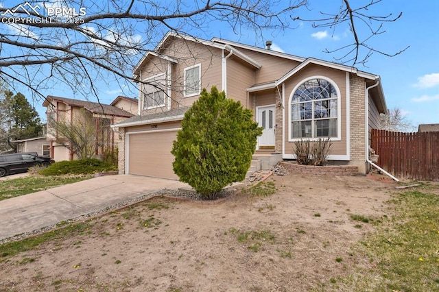 view of front of house featuring fence, an attached garage, brick siding, and concrete driveway