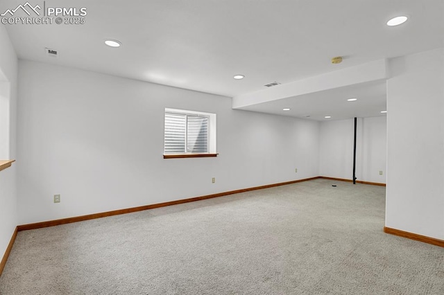 carpeted spare room with visible vents, baseboards, and recessed lighting