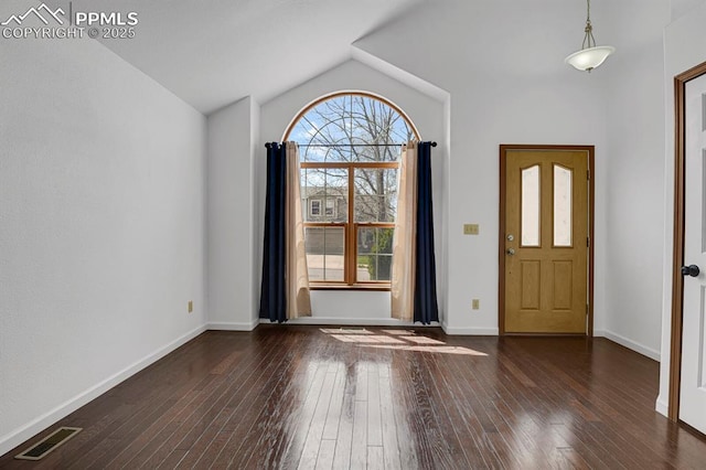 foyer featuring dark wood finished floors, lofted ceiling, visible vents, and baseboards